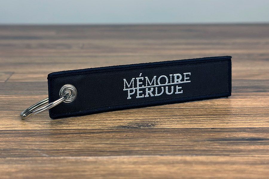 Geweven sleutelhanger met logo Mémoire Perdue